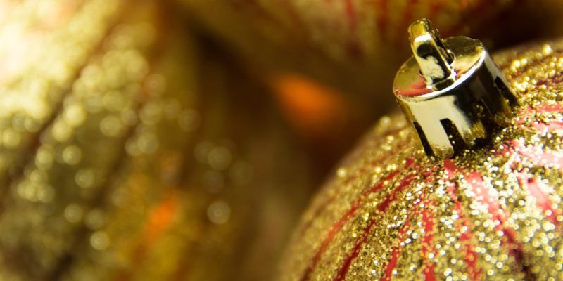 Close-up of glittering red and gold Christmas ornaments