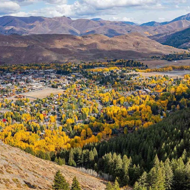 Aerial view of Sun Valley Idaho town surrounded by autumn aspens and mountains