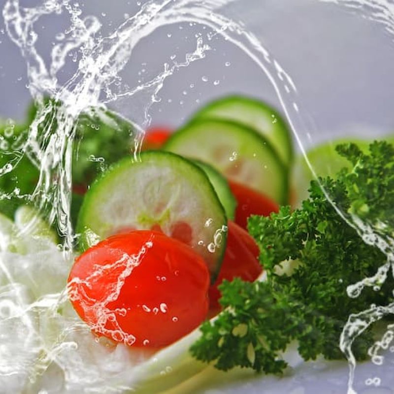Cucumber slices, tomatoes, and parsley splashed with water