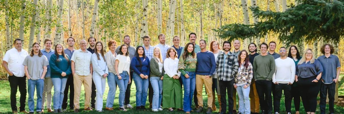 Group team portrait standing in a grove of aspen trees