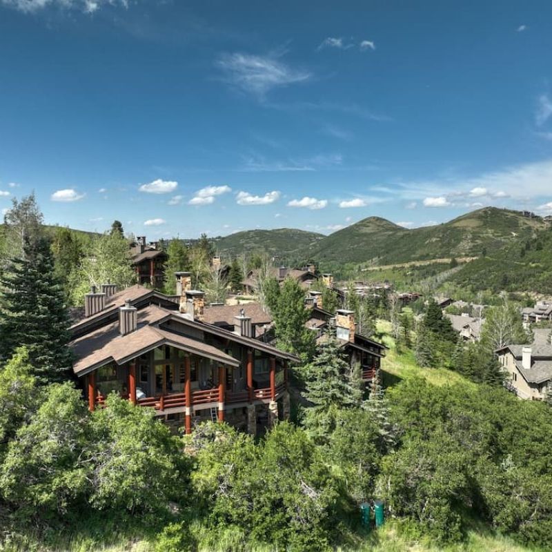 Mountain home with covered deck overlooking forested hills near Park City Utah