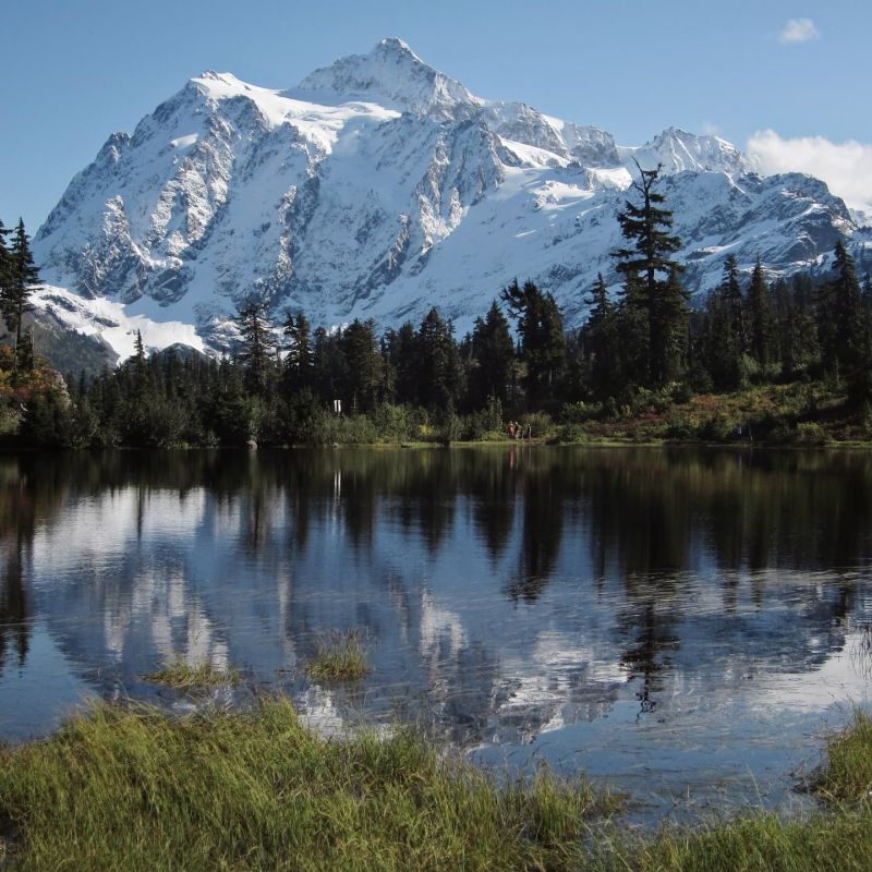 Snow-capped mountain peak reflected in a still alpine lake