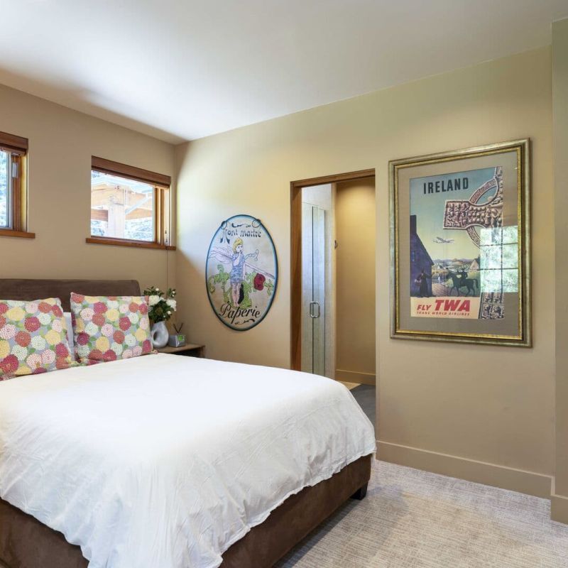 Bedroom with king bed, vintage TWA Ireland poster, and ensuite doorway