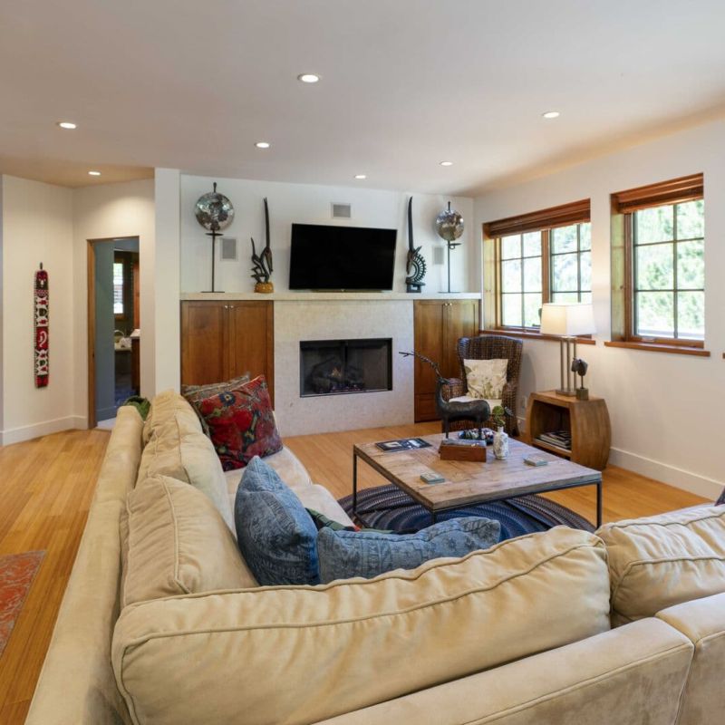 Sun Valley living room with sectional sofa, fireplace, and TV above mantel
