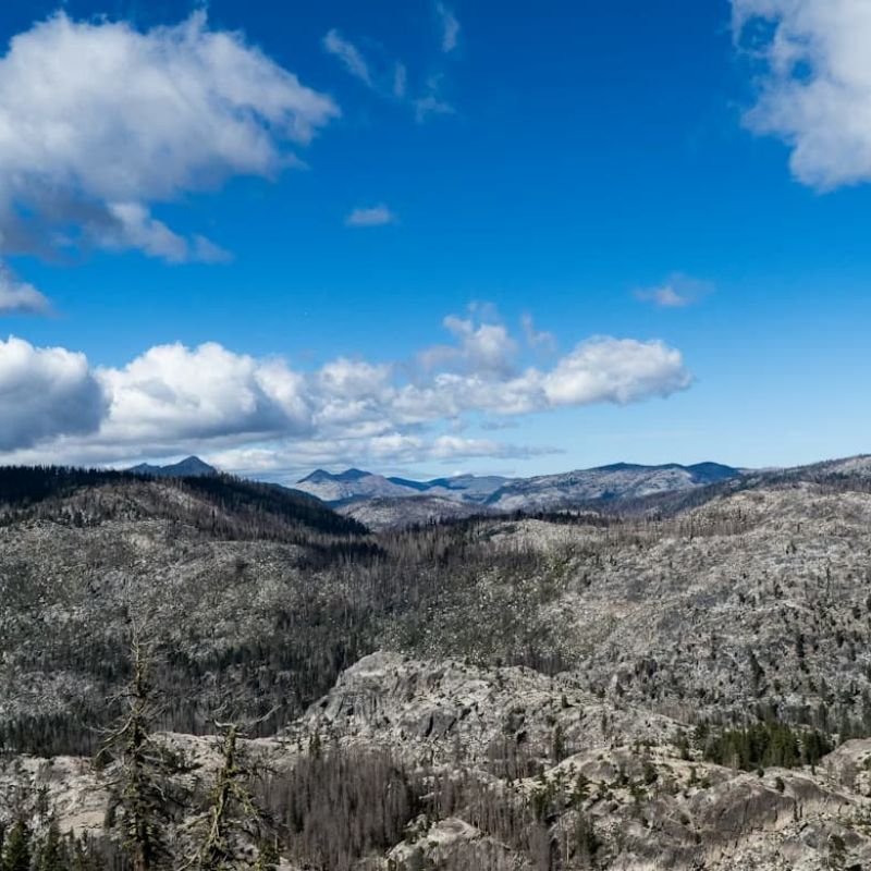Aerial view of a ridgetop ski lodge above snow-covered mountain valleys
