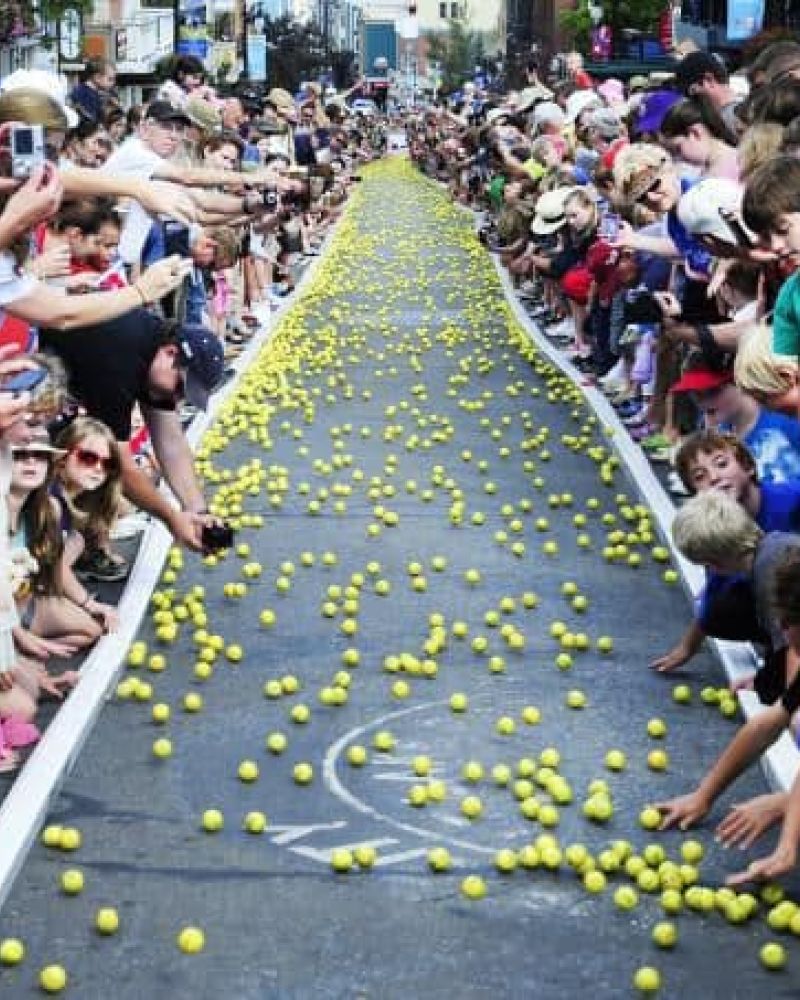 Crowd lining a street watching the Park City tennis ball drop event