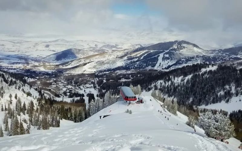 Aerial view of Park City ski resort with mountaintop lift station in winter