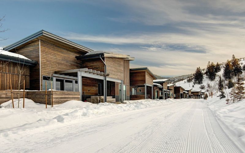 A Park City Ski vacation rental next to a beautiful snowy ski slope.