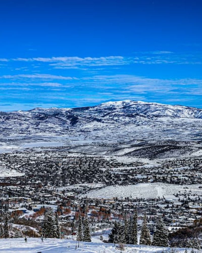 Snow-covered Park City valley and mountains under a clear blue sky