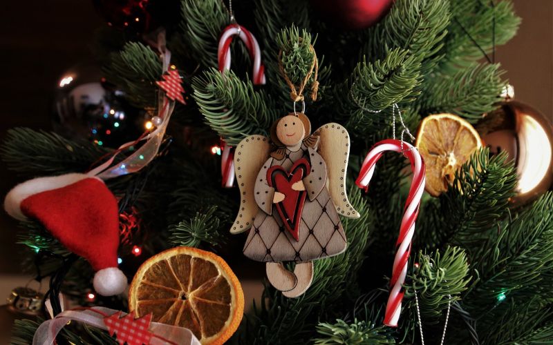 Decorated Christmas tree with angel ornament, candy canes, and dried orange slices