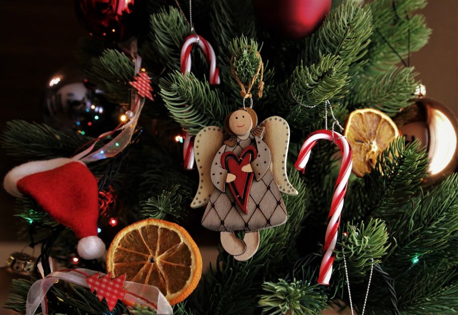 Decorated Christmas tree with angel ornament, candy canes, and dried orange slices