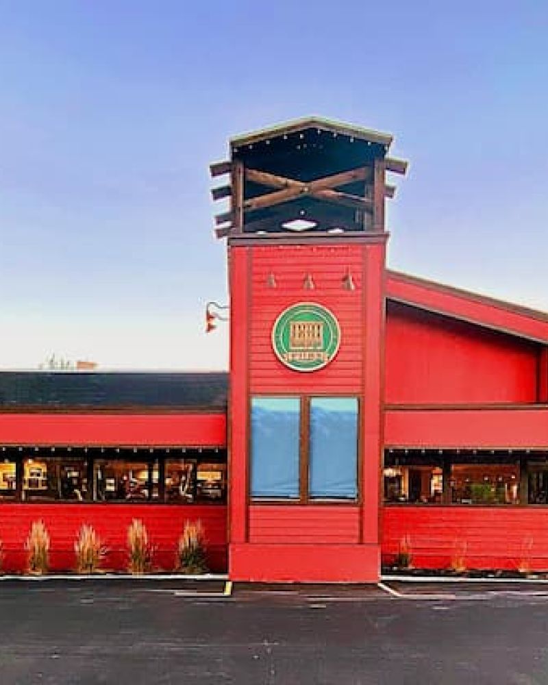 Exterior of Roadhouse Grill, a red wood-sided restaurant with tower entry