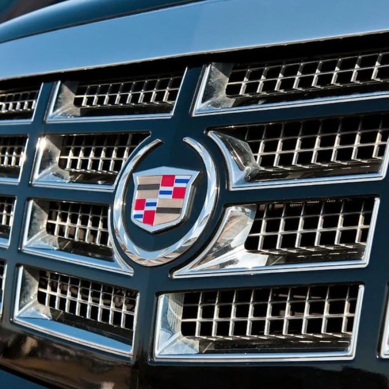 Front grille and crest emblem of a black Cadillac SUV